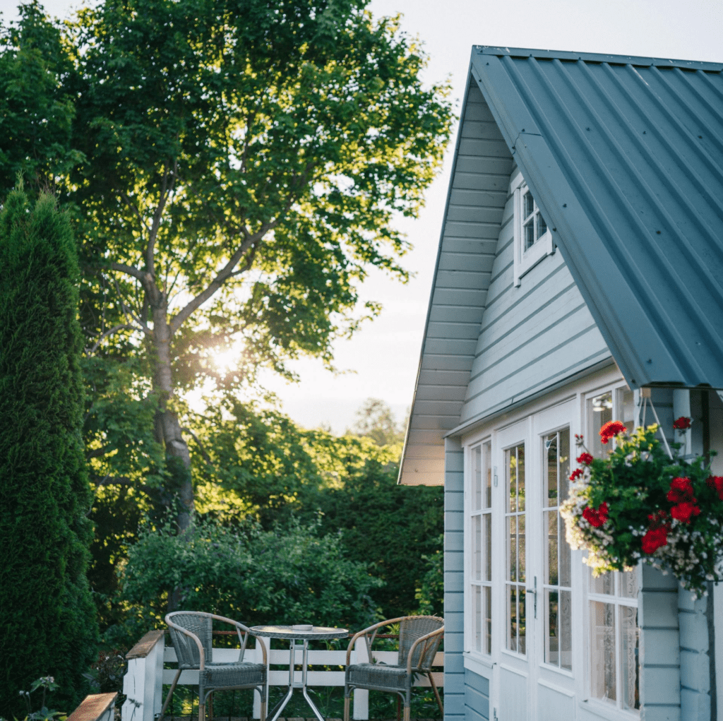 Light blue house with patio and trees.